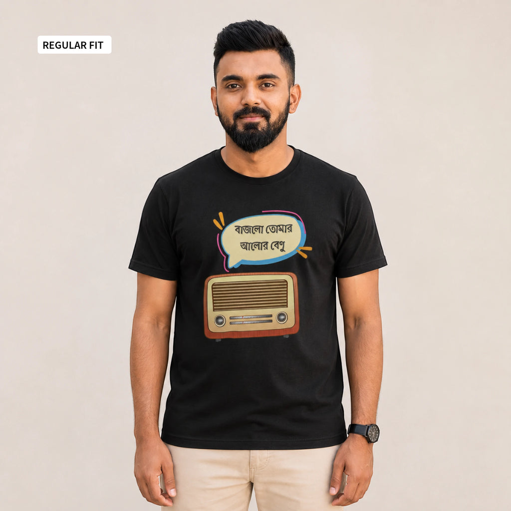 A man wearing a black short-sleeve t-shirt with a retro radio and Bengali text graphic, paired with beige pants, standing against a plain beige background.