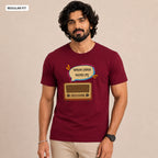 A man wearing a maroon short-sleeve t-shirt with a graphic of a retro radio and Bengali text inside a speech bubble. The image has a beige background and a 'REGULAR FIT' label in the top-left corner.