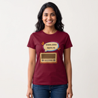 A woman wearing a maroon short-sleeve graphic t-shirt with a cartoon radio and Bengali text bubble, paired with blue jeans, against a plain light background.
