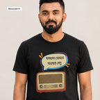A man wearing a black short-sleeve t-shirt with a graphic print of a retro radio and a speech bubble with Bengali text. The image has a 'REGULAR FIT' label in the top-left corner against a plain light gray background.