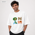 A man wearing an oversized white t-shirt with a colorful graphic that spells 'ONAM' using illustrations. The text 'OVERSIZED FIT' is displayed in the top-left corner.