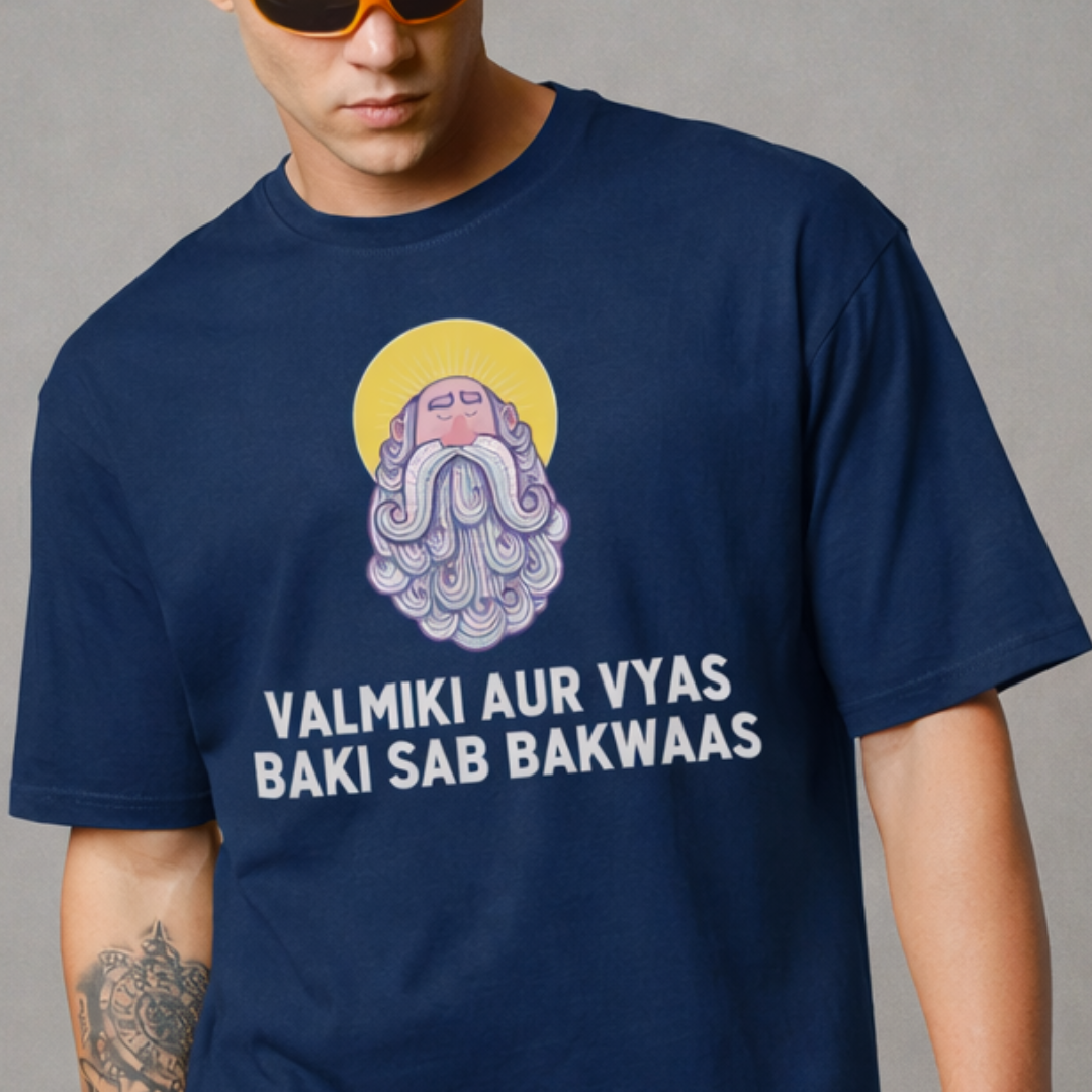 Person wearing a navy blue t-shirt with a graphic design and text on a gray background
