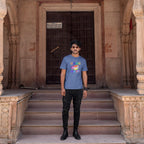 Man standing on steps in front of an ornate building entrance