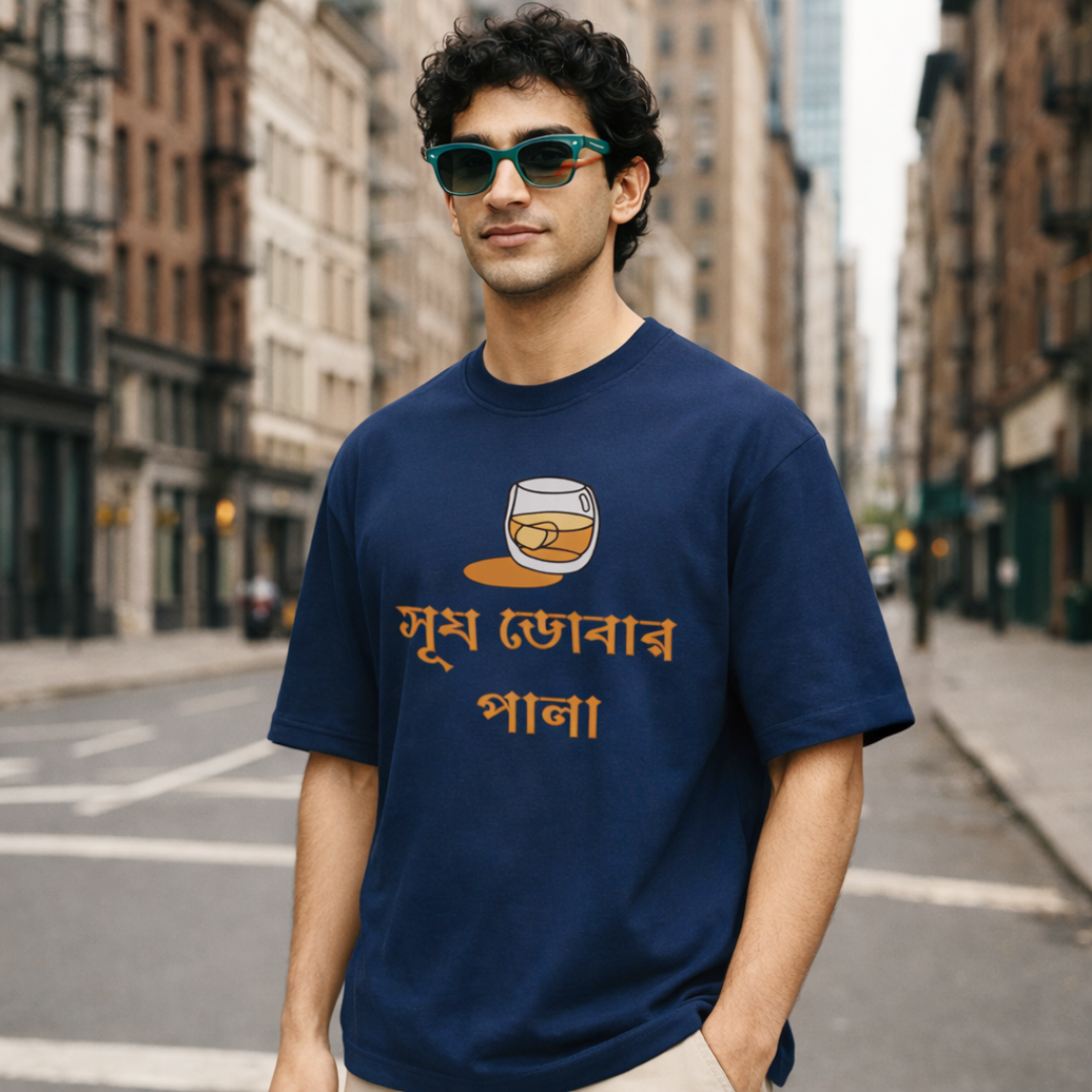 Man wearing a blue t-shirt with a graphic and text on a city street