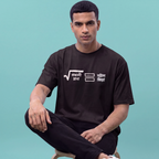 A man wearing a black short-sleeve t-shirt with white Bangla text and graphic symbols on the chest, sitting against a solid teal background.